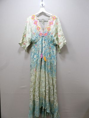 the dress is hanging on a hanger on a wall