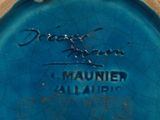 a close up of a blue vase with a name on it