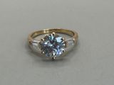 a close up of a ring on a table with a white background