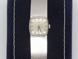 an image of a silver wrist watch with a black velvet band