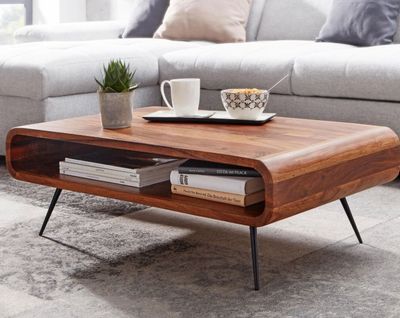 a coffee table with a book on it in a living room