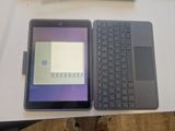 a tablet and a laptop on a table next to each other