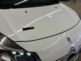a close up of a white car in a garage