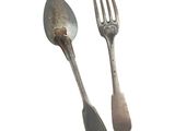 two forks and a spoon sitting next to each other