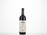 a bottle of red wine sitting on top of a table