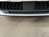 the front bumper of a car with a number plate on it