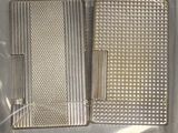 two silver cigarette cases sitting on top of a plastic bag