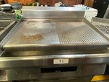 an image of a commercial gas grill in a kitchen