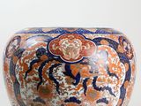 a large vase with an orange and blue design on it