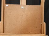 a picture of a wooden easel with a piece of wood on it