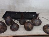 six lamps that are sitting on a wooden table