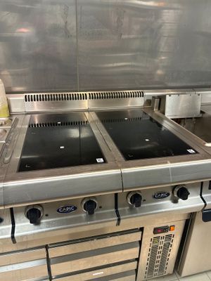 une grande plaque de cuisson en acier inoxydable dans une cuisine professionnelle