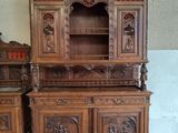 a wooden cabinet with carvings on it in a room