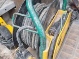 a hose that is sitting on the ground next to a pile of tires
