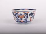 a blue and white bowl with a flower design on it