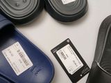 several pairs of black and blue slippers are on a table