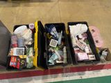 three bins with various items in them on the floor