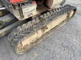 a close up of a tractor tire tracks on the ground