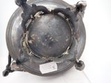 a metal object with a tag on it sitting on a white surface