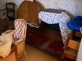 a bed and a chair in a room with a wallpapered wall