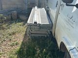 a truck that is parked next to a fence