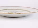 an image of a white bowl with gold trim on a white surface