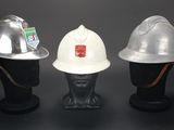 three different types of hard hats on a mannequin head