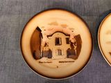 two plates with a picture of a house on them