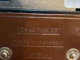 a brown machine with buttons on it sitting on a table