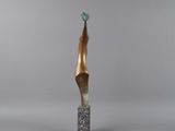 a bronze sculpture of a woman ' s head on a marble base