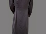 the back of a mannequin wearing a black dress and white shoes