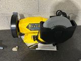 a machine that is sitting on the ground next to a wall