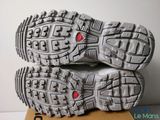 the soles of a pair of running shoes on top of a cardboard box