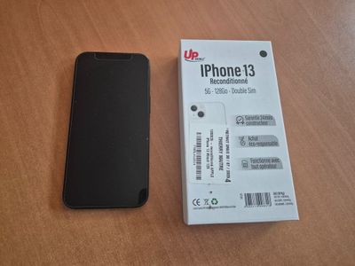 an iphone is sitting next to a box on a table