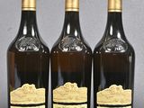 three bottles of wine sitting next to each other on a table