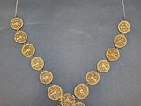 a gold necklace on a mannequin mannequin mannequin mannequin mannequin mannequin mannequin mannequin mannequin