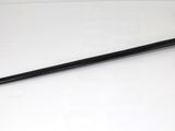 a close up of a sword on a white surface with a black handle