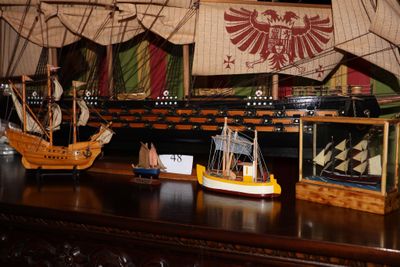 de nombreuses maquettes de bateaux posées sur une table dans une pièce