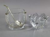 a glass cup with a spoon in it next to a glass bowl with a spoon in it