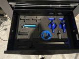 a black box with tools inside of it on the floor