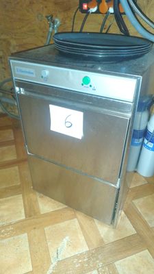 a silver dishwasher sitting on top of a wooden floor