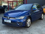 a blue volkswagen golf parked in front of a building