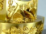 a gold clock sitting on top of a marble table
