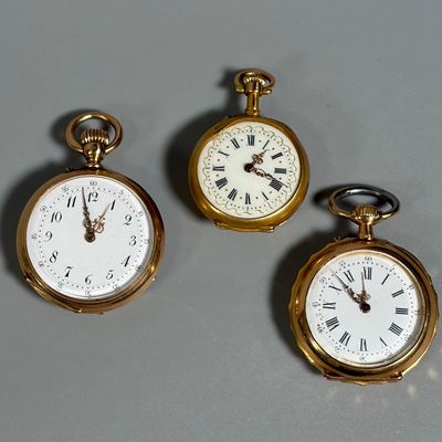 two gold pocket watches with roman numerals and roman numerals on them