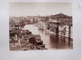 a black and white photo of a river running through a city