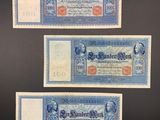 three old german bank notes on a black background