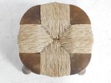 a wooden stool with a rope wrapped around it