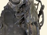 a statue of a man riding a horse on a plate