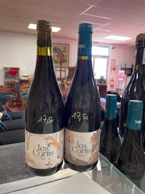several bottles of wine are sitting on a table in a room