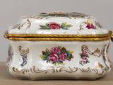 a white box with flowers on it sitting on a table
